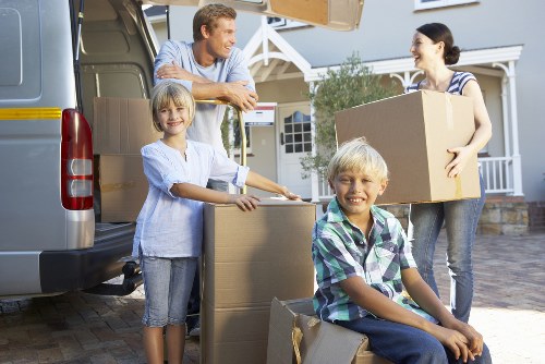 Moving boxes and household items with a Westminster van team