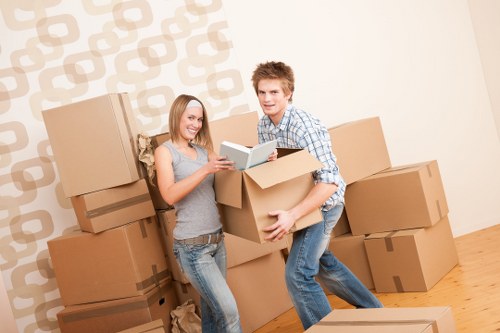 Local furniture pick-up service loading a sofa and table for removal in Westminster